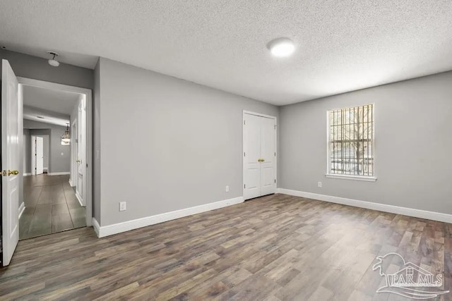 7210 Annandale Dr, Pensacola, FL 32526 - unfurnished room with a textured ceiling and dark wood-type flooring