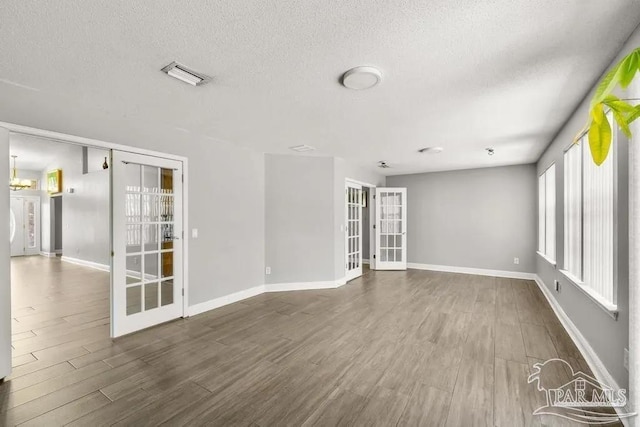 7210 Annandale Dr, Pensacola, FL 32526 - spare room featuring dark hardwood / wood-style flooring and a textured ceiling