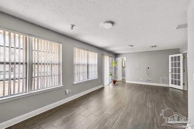 7210 Annandale Dr, Pensacola, FL 32526 - unfurnished room with dark wood-type flooring and a textured ceiling