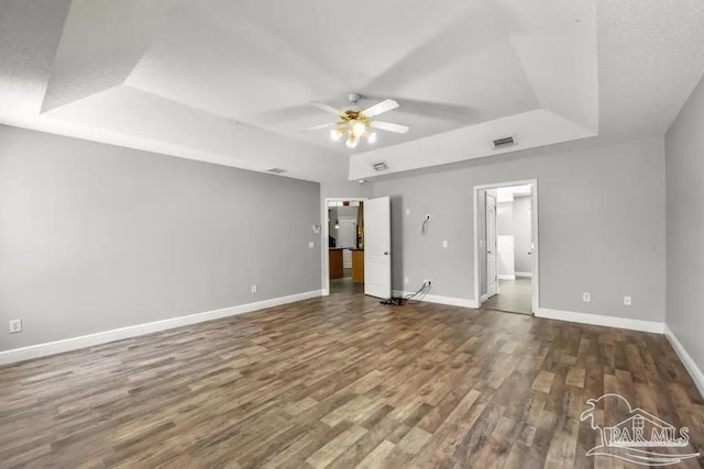 7210 Annandale Dr, Pensacola, FL 32526 - unfurnished bedroom featuring hardwood / wood-style flooring, ceiling fan, and a tray ceiling