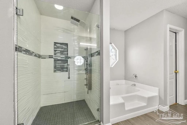 7210 Annandale Dr, Pensacola, FL 32526 - bathroom with plus walk in shower, a textured ceiling, and hardwood / wood-style flooring