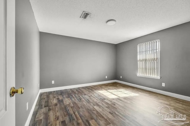 7210 Annandale Dr, Pensacola, FL 32526 - empty room featuring wood-type flooring and a textured ceiling
