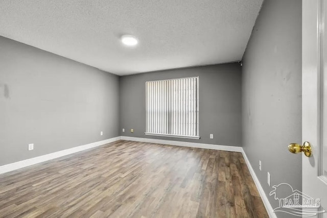 7210 Annandale Dr, Pensacola, FL 32526 - empty room with wood-type flooring and a textured ceiling