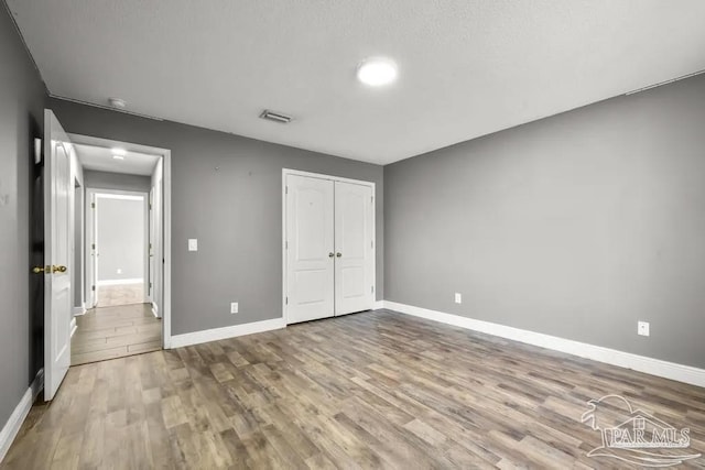 7210 Annandale Dr, Pensacola, FL 32526 - unfurnished bedroom with a closet and wood-type flooring