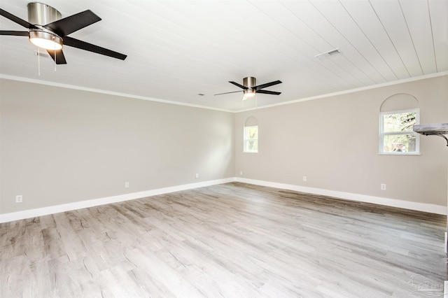 spare room with a wealth of natural light, crown molding, a ceiling fan, and wood finished floors