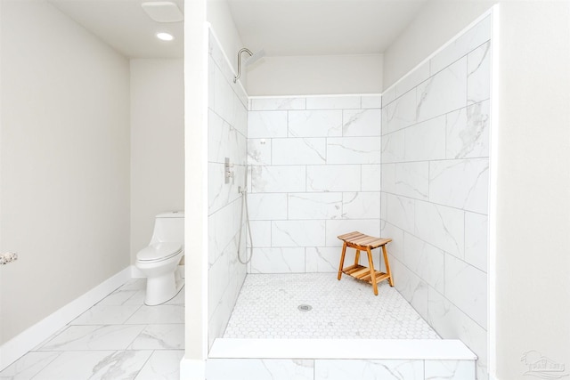 bathroom featuring baseboards, marble finish floor, tiled shower, and toilet