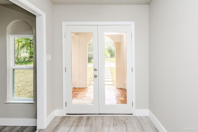 entryway with french doors, baseboards, and wood finished floors