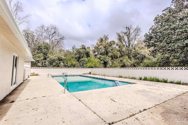 view of swimming pool with a fenced in pool, a patio, and fence