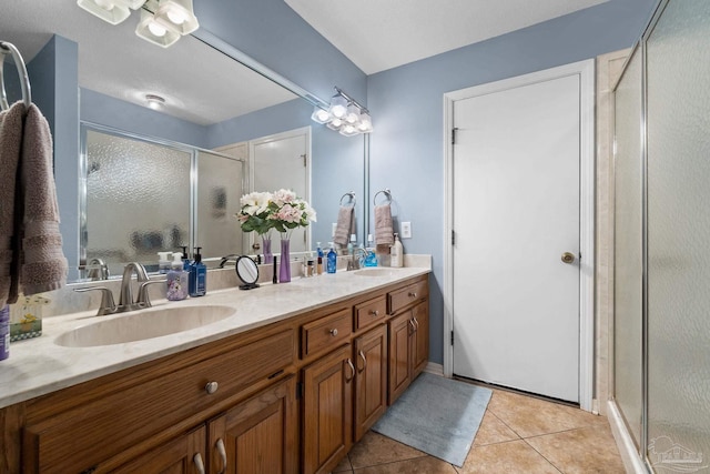 bathroom with vanity, a shower with shower door, and tile patterned flooring