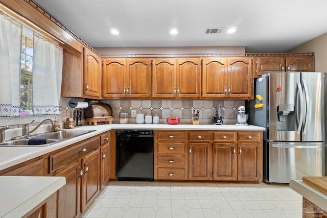 kitchen with black dishwasher, sink, decorative backsplash, and stainless steel refrigerator with ice dispenser