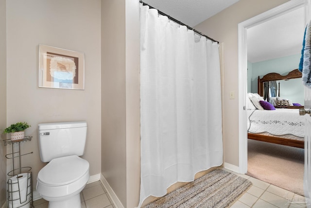 bathroom featuring tile patterned floors and toilet