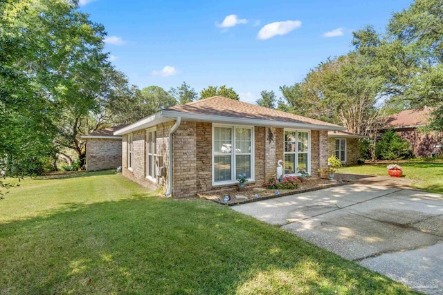 ranch-style house with a patio and a front lawn