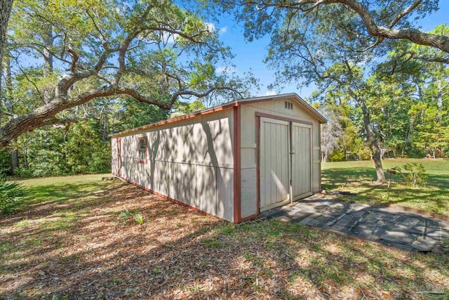 view of outbuilding featuring a lawn