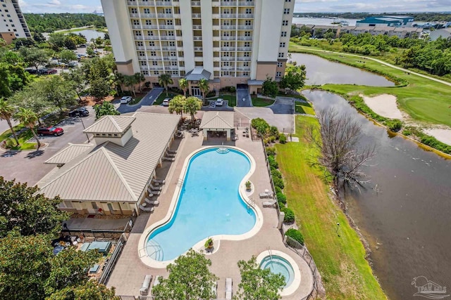 view of swimming pool featuring a water view and a patio