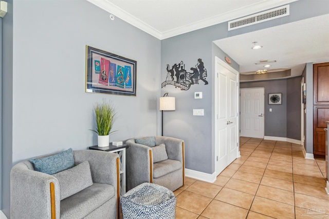 living area with crown molding and light tile patterned floors