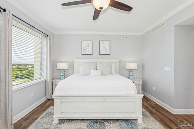 bedroom with dark wood-type flooring, ceiling fan, and ornamental molding