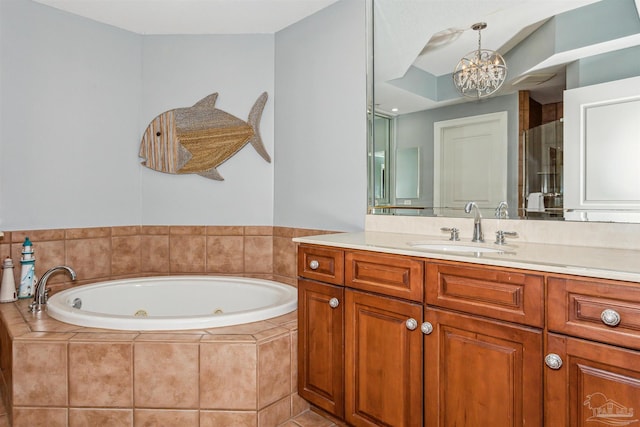 bathroom featuring a relaxing tiled tub, vanity, and a chandelier