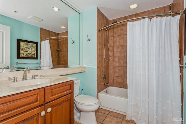 full bathroom featuring vanity, tile patterned floors, toilet, and shower / bath combo with shower curtain