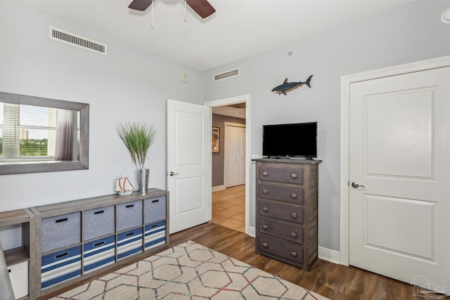 bedroom with dark wood-type flooring and ceiling fan