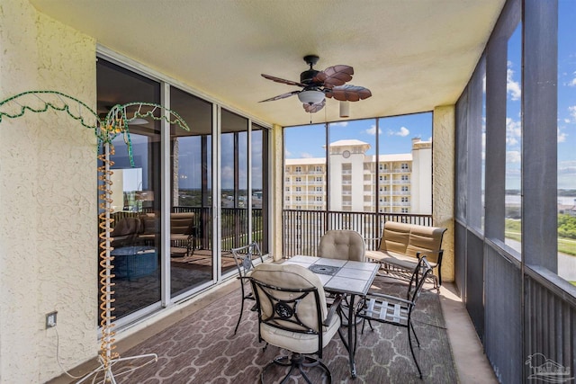 sunroom featuring ceiling fan