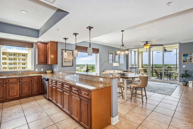 kitchen featuring light tile patterned floors, kitchen peninsula, ceiling fan with notable chandelier, light stone counters, and sink