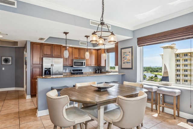 tiled dining area featuring crown molding