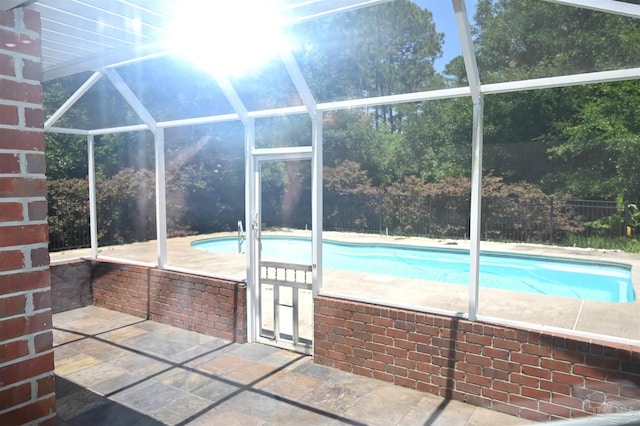 view of pool with a patio and a lanai