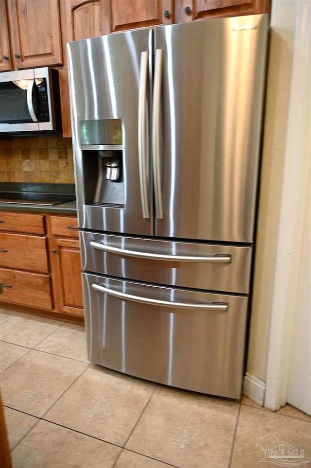 kitchen with stainless steel appliances and light tile patterned floors