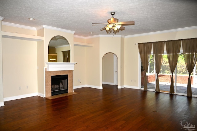 unfurnished living room featuring a textured ceiling, ceiling fan, hardwood / wood-style floors, a tiled fireplace, and ornamental molding