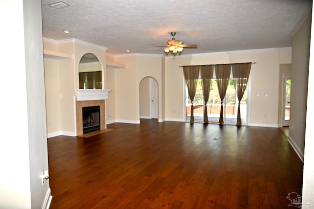 unfurnished living room with a fireplace, ceiling fan, hardwood / wood-style flooring, crown molding, and a textured ceiling