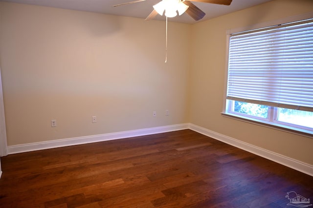 empty room featuring dark hardwood / wood-style floors and ceiling fan