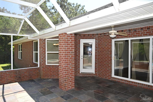 unfurnished sunroom with a skylight and ceiling fan