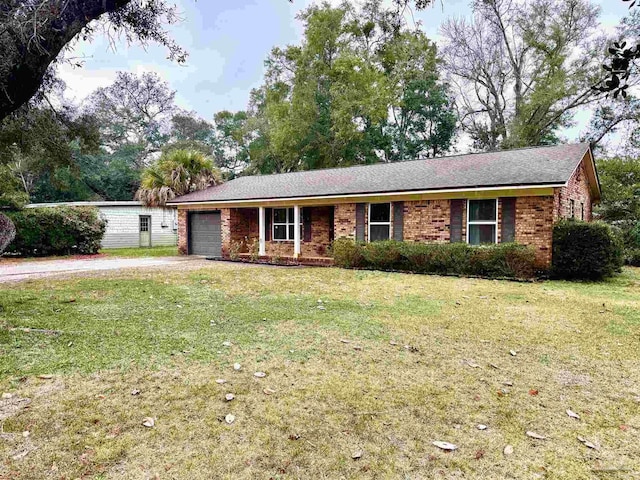 ranch-style home featuring a garage and a front yard