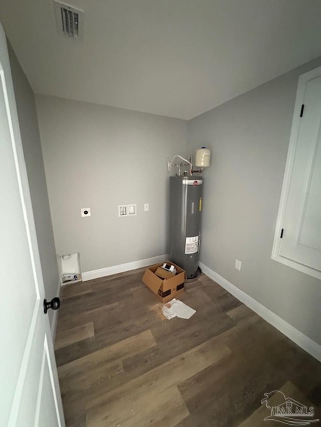 utility room with visible vents and electric water heater