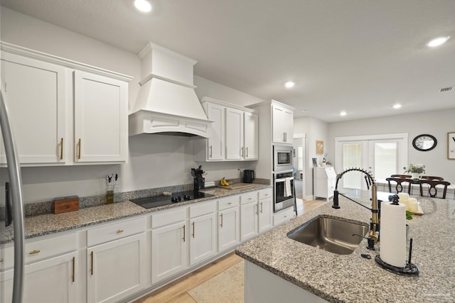 5534 Blake Ln, Pace, FL 32571 - kitchen featuring stainless steel appliances, a sink, white cabinetry, premium range hood, and recessed lighting