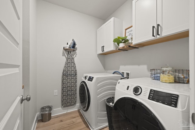 5534 Blake Ln, Pace, FL 32571 - laundry room with cabinet space, washer and dryer, light wood-type flooring, and baseboards