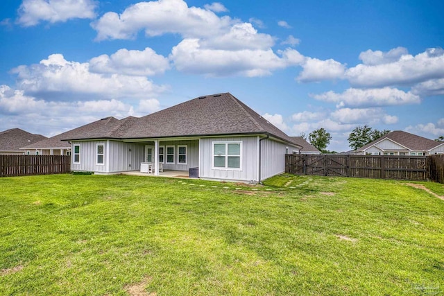 5534 Blake Ln, Pace, FL 32571 - back of property with board and batten siding, a patio area, and roof with shingles