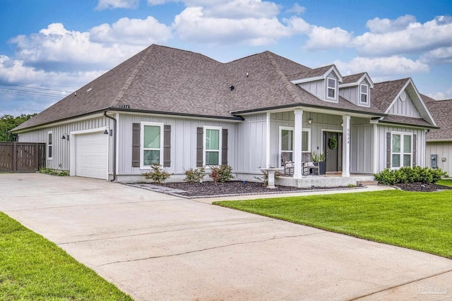 5534 Blake Ln, Pace, FL 32571 - view of front of house featuring board and batten siding, a porch, concrete driveway, a garage, and a shingled roof