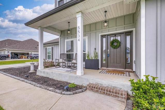 5534 Blake Ln, Pace, FL 32571 - doorway to property featuring covered porch and board and batten siding