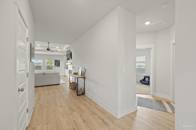 5534 Blake Ln, Pace, FL 32571 - corridor with a tray ceiling, light wood finished floors, recessed lighting, and baseboards
