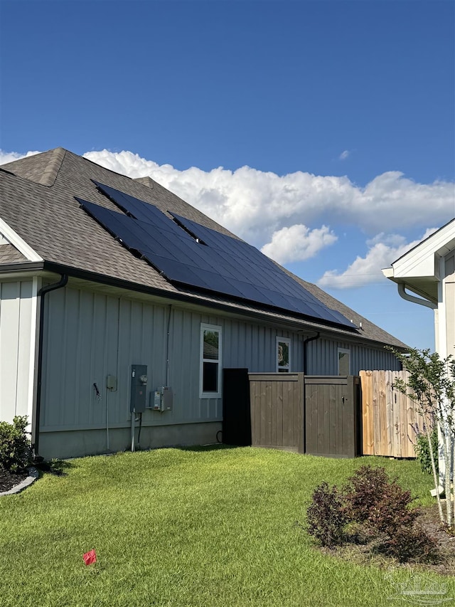 5534 Blake Ln, Pace, FL 32571 - view of side of home featuring roof with shingles, solar panels, and board and batten siding