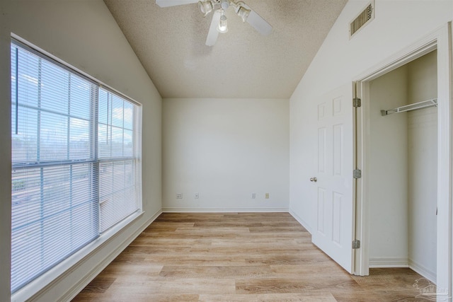 7101 Joy St Unit D5, Pensacola, FL 32504 - unfurnished bedroom with a textured ceiling, lofted ceiling, light wood-type flooring, a closet, and ceiling fan