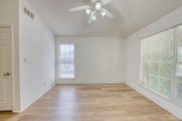 7101 Joy St Unit D5, Pensacola, FL 32504 - unfurnished room with vaulted ceiling, a textured ceiling, light wood-style floors, ceiling fan, and baseboards