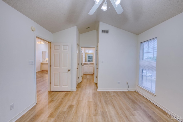 7101 Joy St Unit D5, Pensacola, FL 32504 - unfurnished room with ceiling fan, light wood-style flooring, lofted ceiling, baseboards, and a textured ceiling