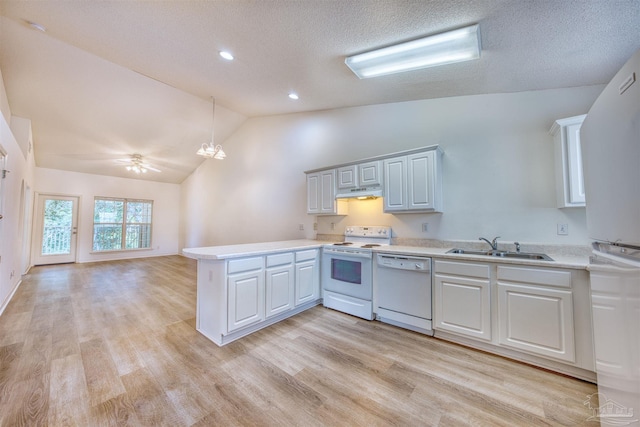 7101 Joy St Unit D5, Pensacola, FL 32504 - kitchen featuring white appliances, light countertops, a peninsula, lofted ceiling, and a sink