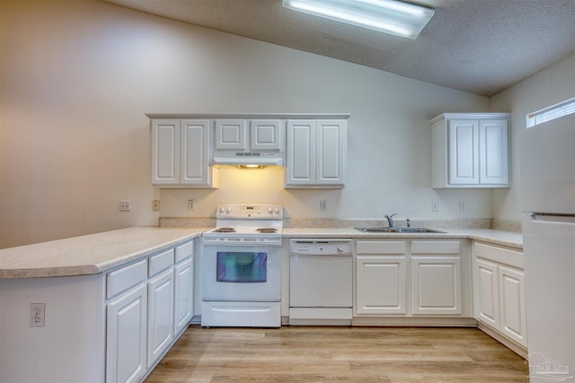 7101 Joy St Unit D5, Pensacola, FL 32504 - kitchen with white appliances, under cabinet range hood, vaulted ceiling, a sink, and a peninsula