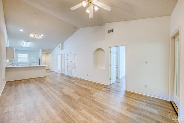 7101 Joy St Unit D5, Pensacola, FL 32504 - unfurnished living room featuring ceiling fan, light wood-type flooring, a chandelier, baseboards, and high vaulted ceiling