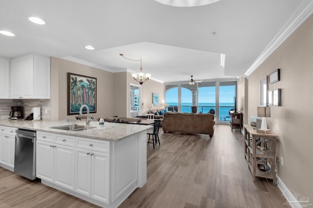 kitchen featuring sink, dishwasher, white cabinetry, a water view, and light stone counters