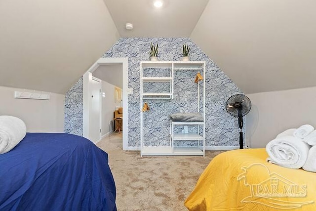 bedroom featuring baseboards, wallpapered walls, carpet floors, and lofted ceiling