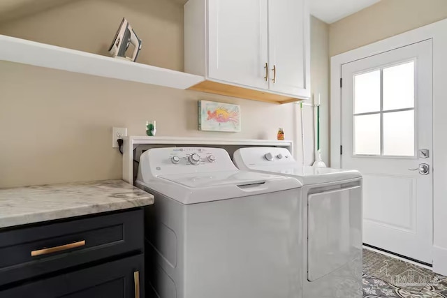 laundry area featuring separate washer and dryer and cabinet space